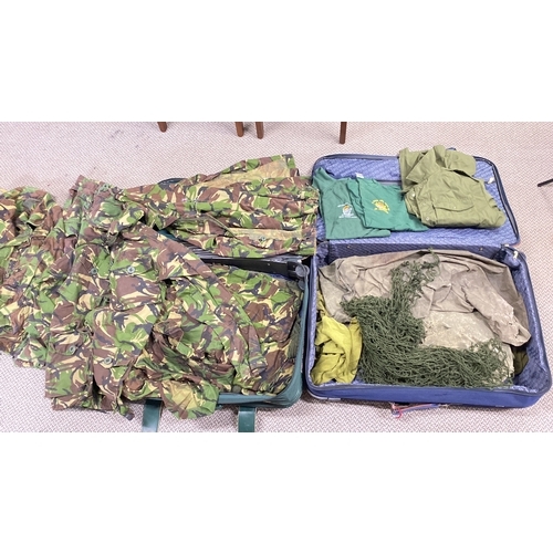 431 - Collection of military clothing, featuring camouflage jackets, shirts, and netting. Includes various... 