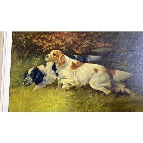 451 - A framed print of dogs, signed by artist.  Measuring 51x61cm.