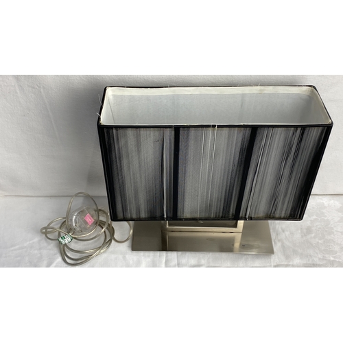 102 - Contemporary rectangular table lamp with a ribbed black fabric shade and a brushed metal base.