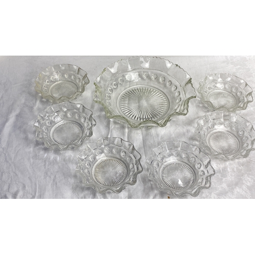 105 - Set of six clear pressed glass bowls featuring ruffled edges and decorative detailing, accompanied b... 