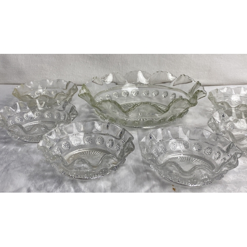 105 - Set of six clear pressed glass bowls featuring ruffled edges and decorative detailing, accompanied b... 