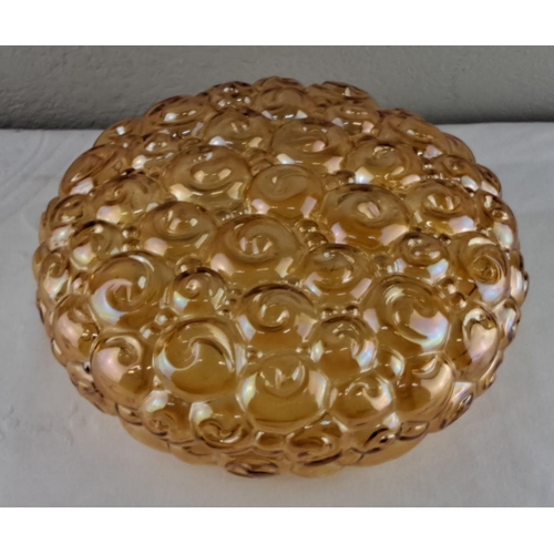 18 - Amber carnival glass lampshade featuring an embossed swirl design, 24cm diameter.