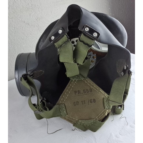 30 - Vintage military gas mask and canvas carrying bag, featuring dual eyepieces and filter attachment.