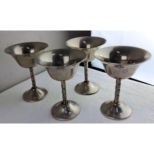 32 - Set of four engraved silver plated goblets with ornate stems, accompanied by a silver plated three-a... 