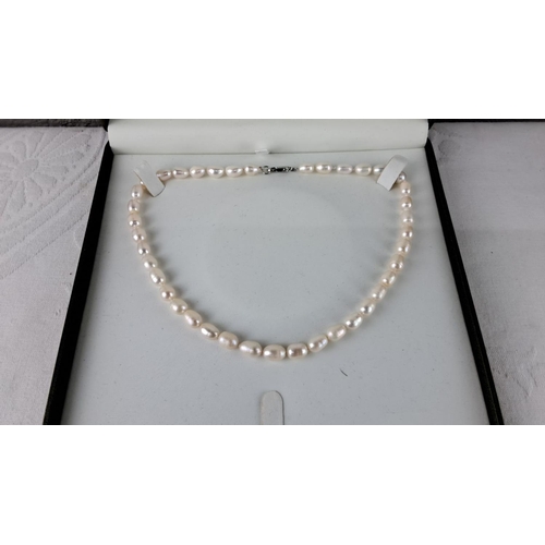 56 - Pearl necklace with Sterling Silver clasp. Oval freshwater pearls.