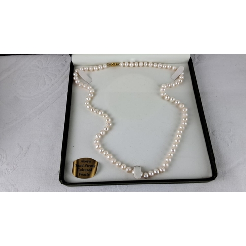 57 - Akoya hand-strung cultured pearl necklace with gold clasp. Lustrous, round pearls.