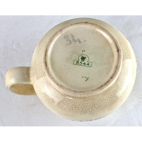 60 - Ceramic advertising jug featuring 