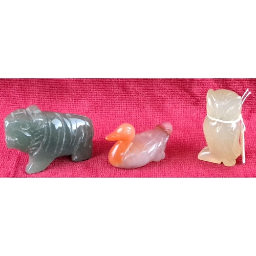 76 - Set of three carved jade animal figures: tiger, duck, and owl. Each features unique coloring and fin... 