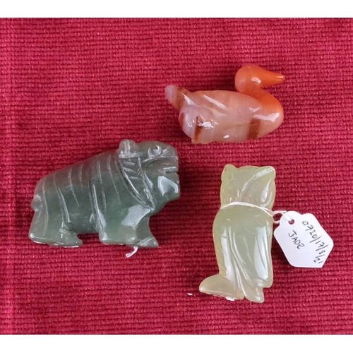 76 - Set of three carved jade animal figures: tiger, duck, and owl. Each features unique coloring and fin... 