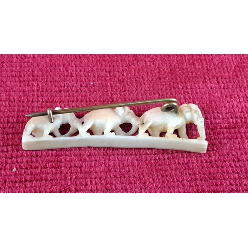 78 - Delicately carved bone pin featuring three elephants, secured with a metal pin back. From the early ... 