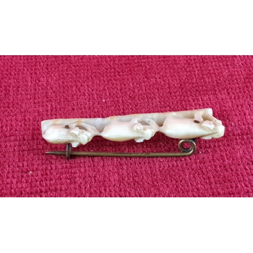 78 - Delicately carved bone pin featuring three elephants, secured with a metal pin back. From the early ... 