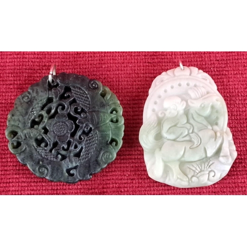 81 - Green and white carved jade pendants with intricate designs, featuring flora and fauna motifs.