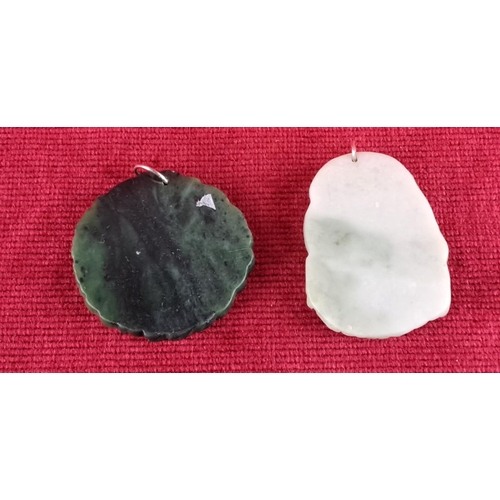 81 - Green and white carved jade pendants with intricate designs, featuring flora and fauna motifs.