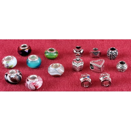 84 - Assorted bead collection featuring colorful glass charms with varied designs, including floral and h... 