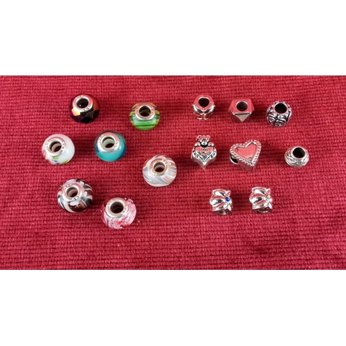 84 - Assorted bead collection featuring colorful glass charms with varied designs, including floral and h... 