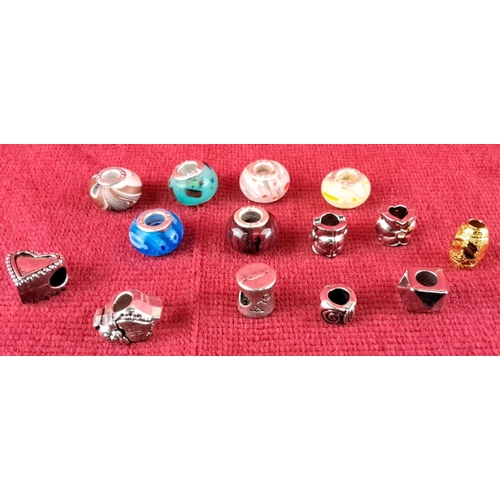 86 - Collection of 14 assorted charm beads, featuring glass and metal designs with various shapes and col... 