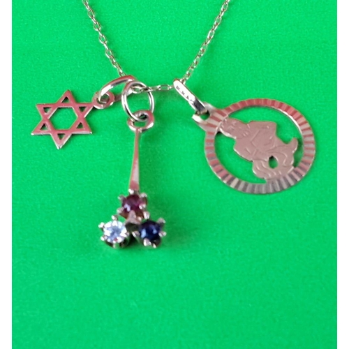 90 - 9ct gold chained necklace with three charms: Star of David, cut-out figure charm, and gemstone trio ... 