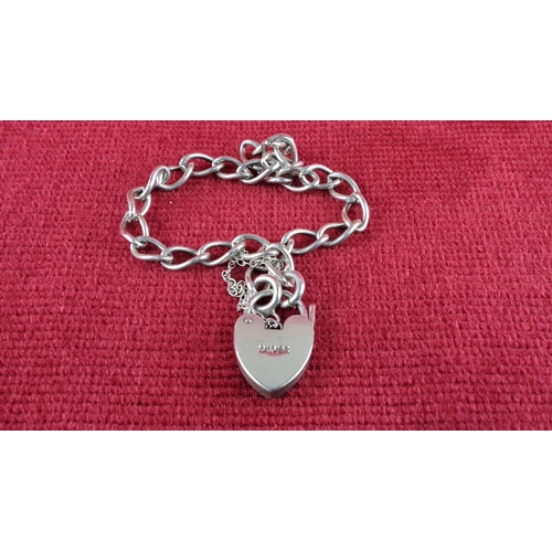 92 - Sterling silver charm bracelet with seven charms, including a heart lock, each intricately designed.... 