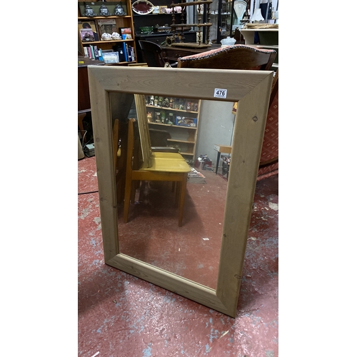 476 - Rectangular mirror with a wooden frame. 95cm x 68cm.