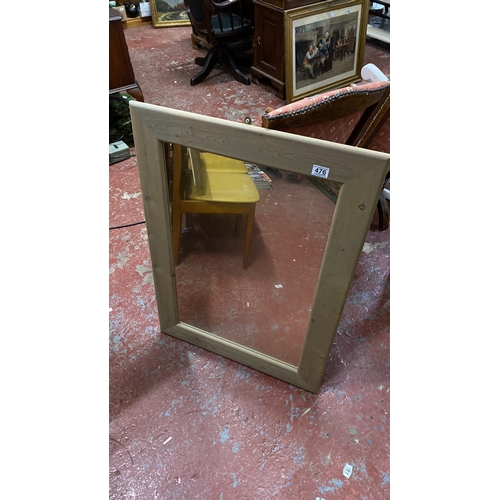 476 - Rectangular mirror with a wooden frame. 95cm x 68cm.