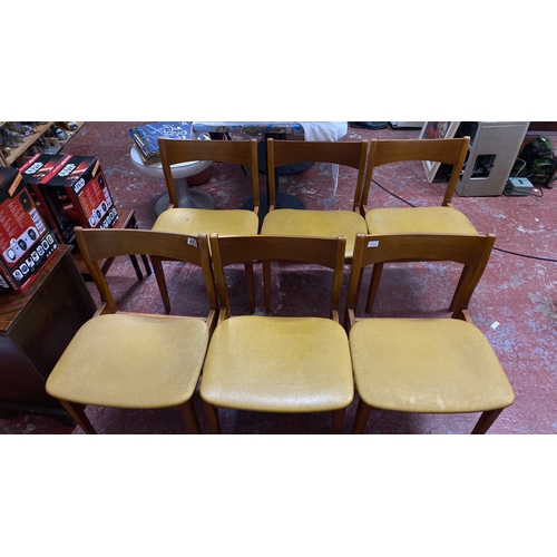 482 - Stunning set of six Mid-Century Modern dining chairs with wood frames and mustard-toned vinyl seats.