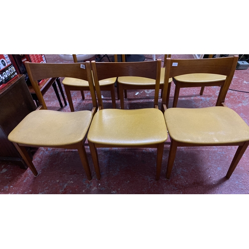 482 - Stunning set of six Mid-Century Modern dining chairs with wood frames and mustard-toned vinyl seats.