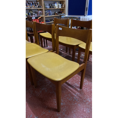 482 - Stunning set of six Mid-Century Modern dining chairs with wood frames and mustard-toned vinyl seats.