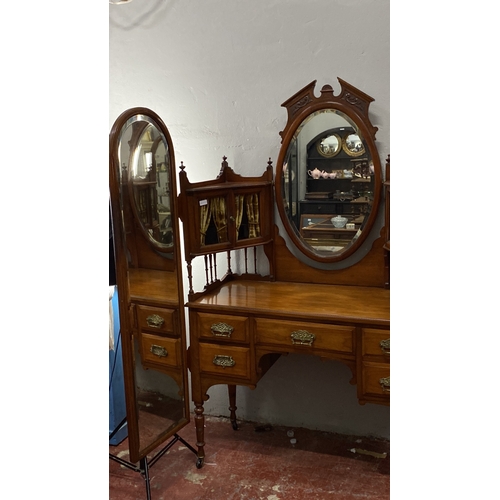 488 - Mahogany dressing table with oval mirror and ornate brass handles, featuring five drawers and side s... 