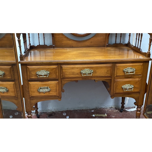 488 - Mahogany dressing table with oval mirror and ornate brass handles, featuring five drawers and side s... 