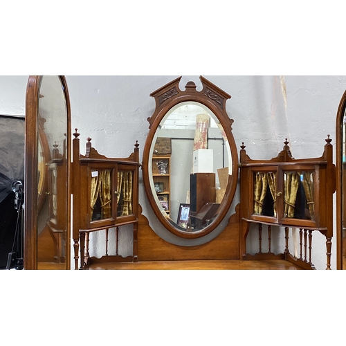 488 - Mahogany dressing table with oval mirror and ornate brass handles, featuring five drawers and side s... 