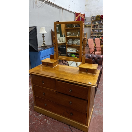 493 - Oak dressing table with three drawers and a swiveling mirror, featuring turned supports. Approximate... 