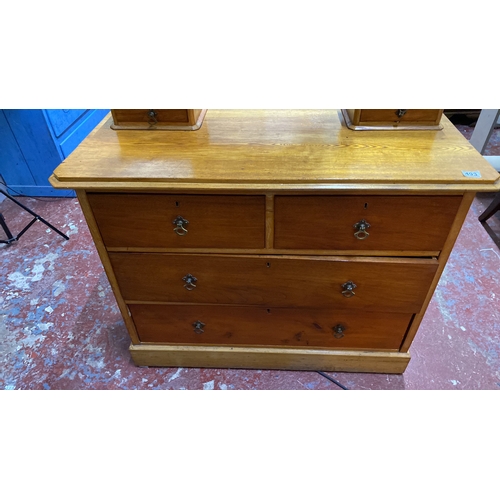 493 - Oak dressing table with three drawers and a swiveling mirror, featuring turned supports. Approximate... 