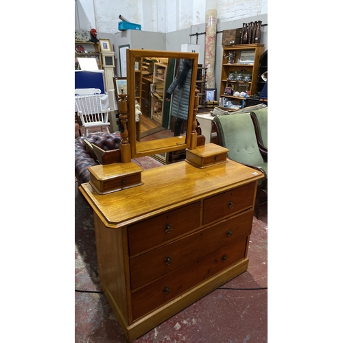 493 - Oak dressing table with three drawers and a swiveling mirror, featuring turned supports. Approximate... 