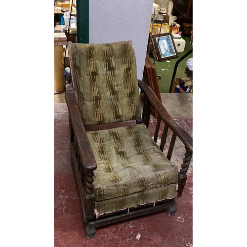 494 - Antique/ vintage Oak rocker armchair with green patterned upholstery, featuring turned arm supports ... 