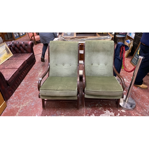 495 - Pair of Mid-Century Parker Knoll armchairs with green upholstery and curved wooden frames.