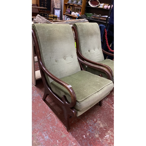 495 - Pair of Mid-Century Parker Knoll armchairs with green upholstery and curved wooden frames.