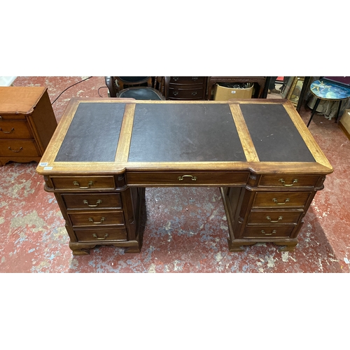 502 - Stunning antique style partners desk featuring a brown leather top with three panels, brass handles,... 