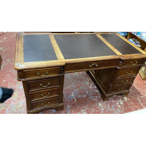 502 - Stunning antique style partners desk featuring a brown leather top with three panels, brass handles,... 