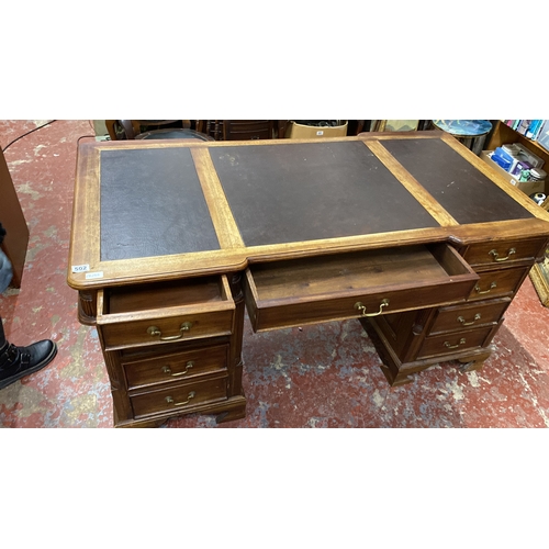 502 - Stunning antique style partners desk featuring a brown leather top with three panels, brass handles,... 