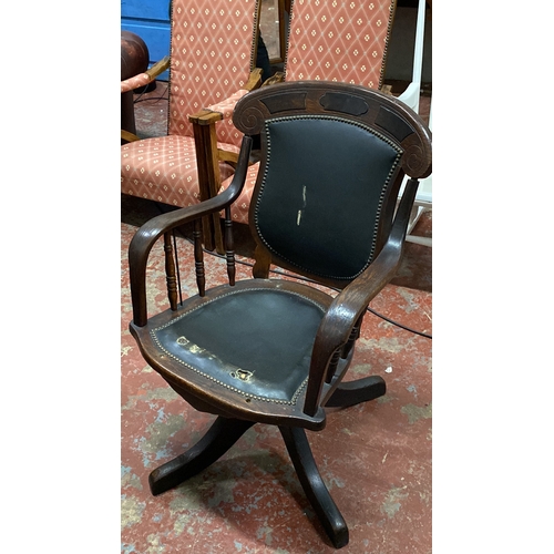 503 - Oak swivel desk chair in Victorian style, featuring turned arm supports and a leather backrest.