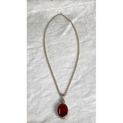 105 - Sterling Silver necklace with large fob featuring an oval red gemstone with hallmark 925, total weig... 