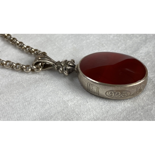 105 - Sterling Silver necklace with large fob featuring an oval red gemstone with hallmark 925, total weig... 