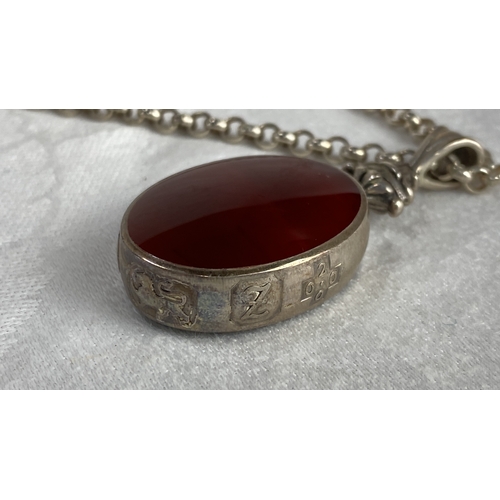 105 - Sterling Silver necklace with large fob featuring an oval red gemstone with hallmark 925, total weig... 