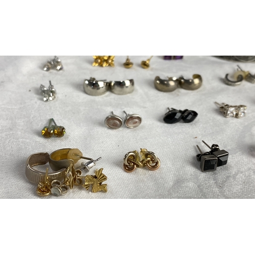 110 - Earring collection features gold, silver, and gemstone styles, including stud and hoop designs.