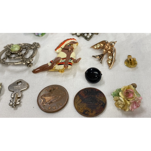 115 - Collection of vintage brooches and pins includes floral motifs, enamel detailing, and various gemsto... 