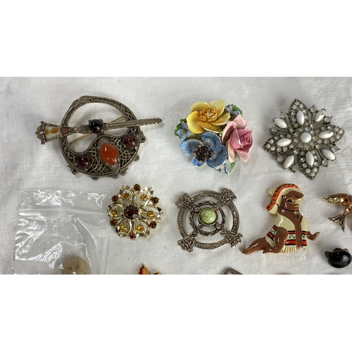 115 - Collection of vintage brooches and pins includes floral motifs, enamel detailing, and various gemsto... 