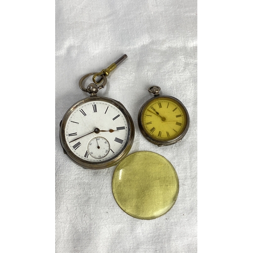 117 - Two antique silver cased pocket watches with key. Engraved cases, one features Roman numerals on a w... 