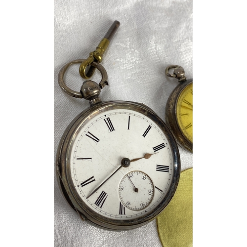 117 - Two antique silver cased pocket watches with key. Engraved cases, one features Roman numerals on a w... 