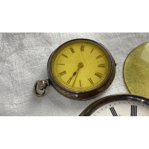 117 - Two antique silver cased pocket watches with key. Engraved cases, one features Roman numerals on a w... 