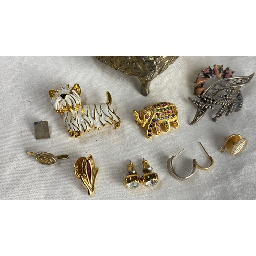 123 - Collection of vintage brooches and earrings featuring gold-tone metal and enamel accents. Includes h... 